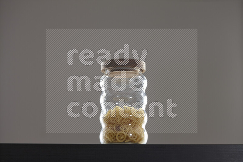 Snacks in a glass jar on black background