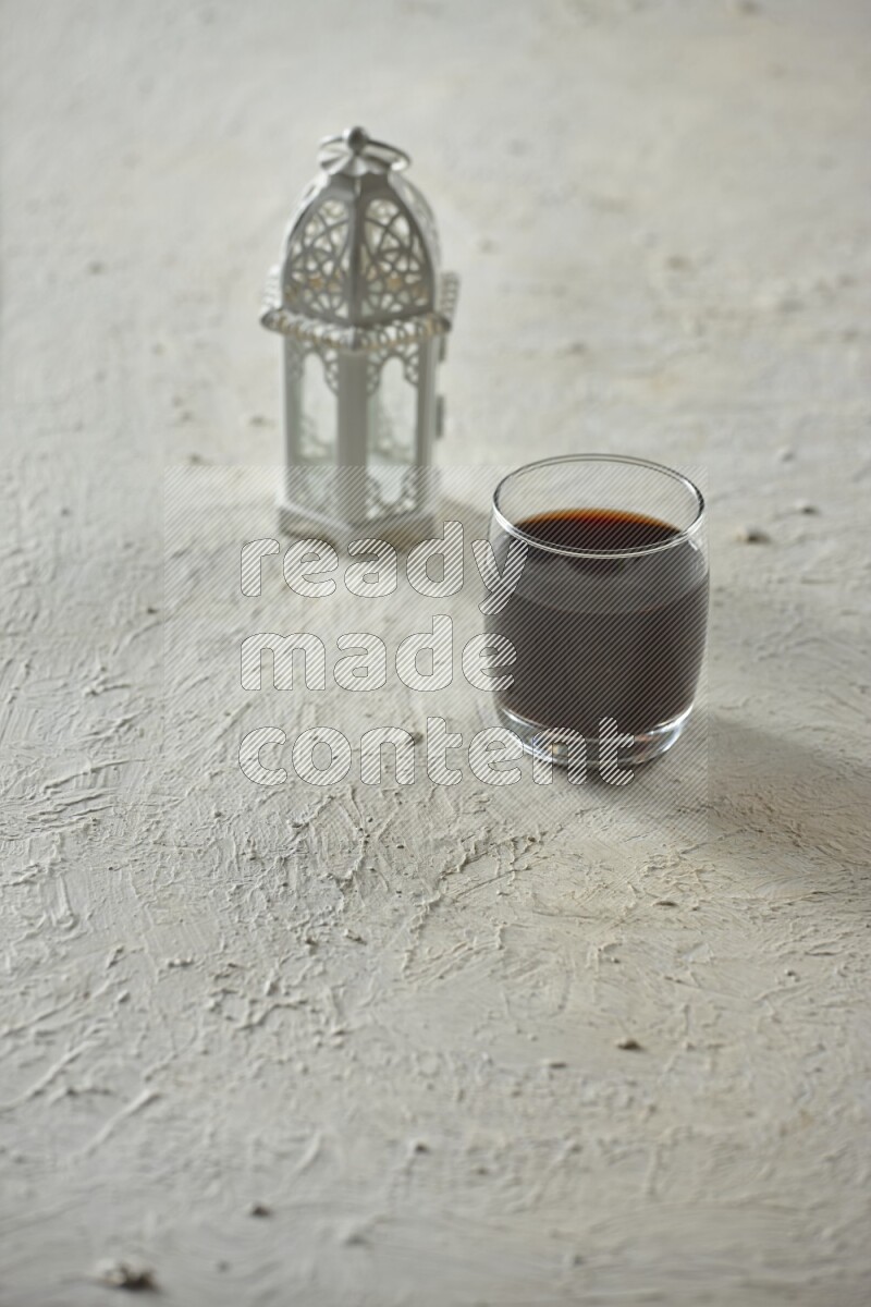 A white lantern with different drinks, dates, nuts, prayer beads and quran on white background