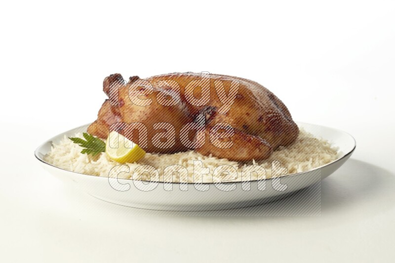 white  basmati Rice with  whole roasted chicken  on a white plate with a silver rim direct  on white background