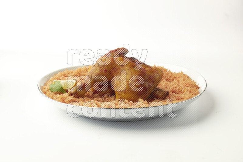 red basmati Rice with  kabsa chicken pieces on a white plate with a silver rim direct  on white background