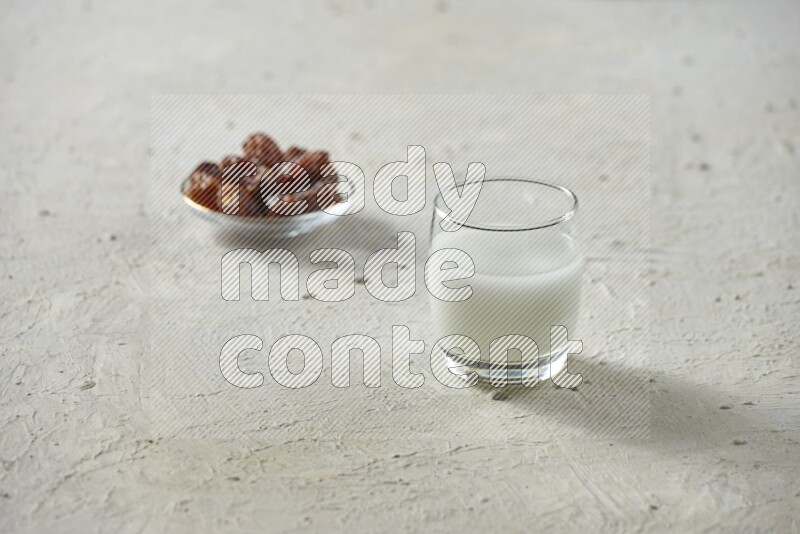 Cold drinks in a glass cup with dates such as water, tamarind, qamar eldin, sobia, milk and hibiscus on textured white background