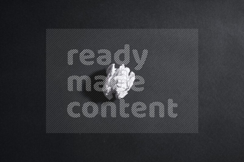 Crumpled notebook sheet on black background