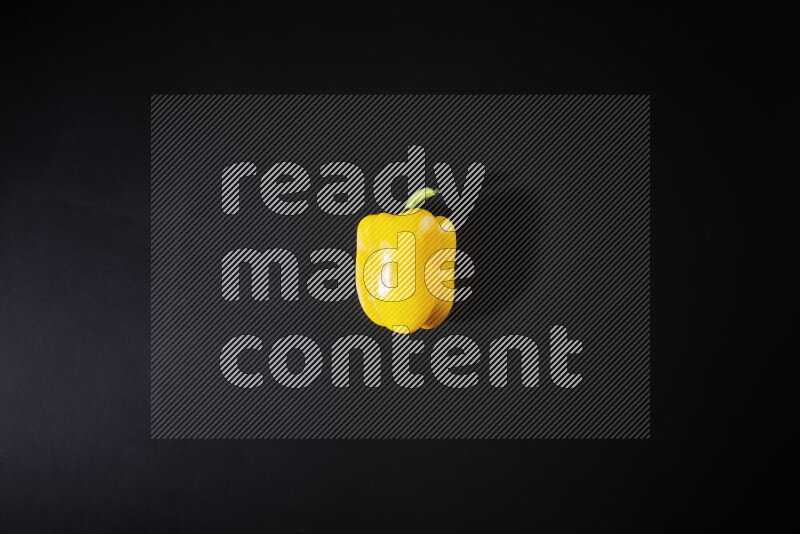 Yellow bell pepper on black background