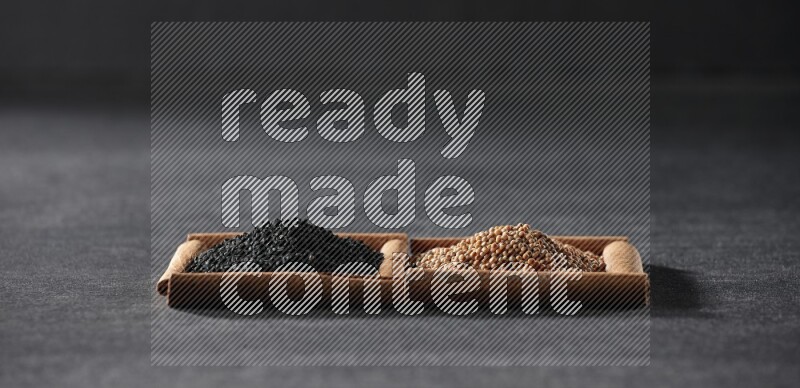 2 squares of cinnamon sticks full of mustard seeds and black seeds on black flooring