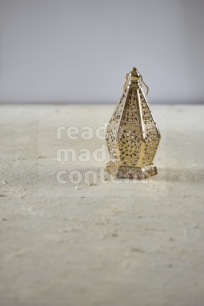A lantern placed on a textured white background