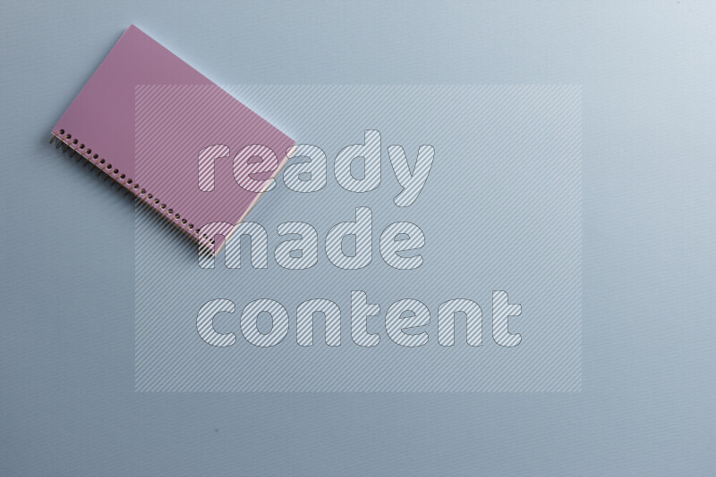 دفتر ملاحظات أرجواني مع مستلزمات مدرسية مختلفة على خلفية زرقاء