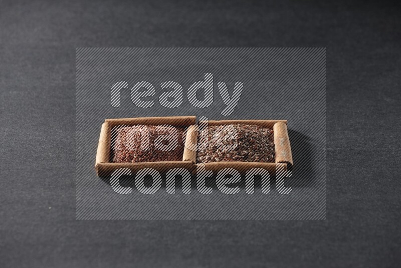 2 squares of cinnamon sticks full of garden cress and flaxseeds on black flooring