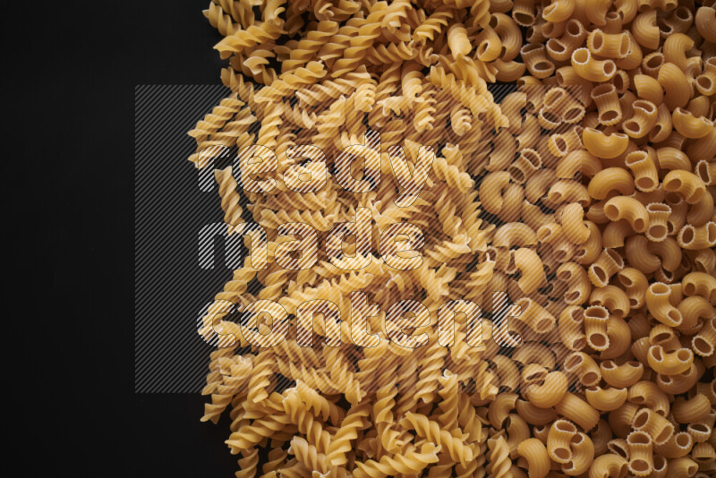 Different pasta types on black background