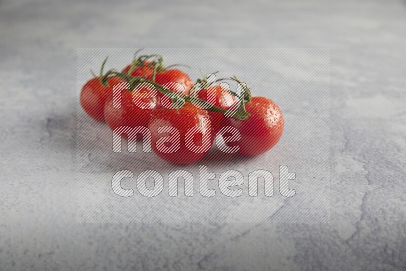 Red cherry tomato vein on a light grey textured background 45 degree