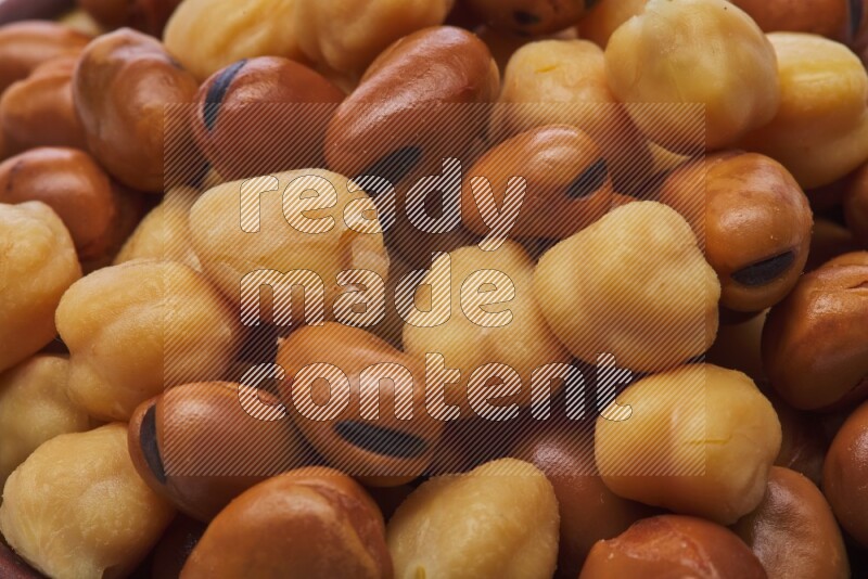 Close up shot of cooked fava beans (foul) & chickpeas on white background