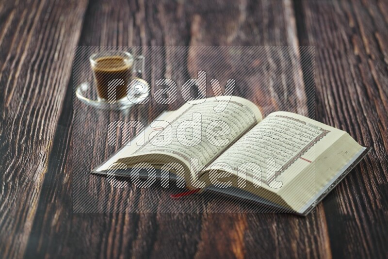 Quran with dates, prayer beads and different drinks all placed on wooden background
