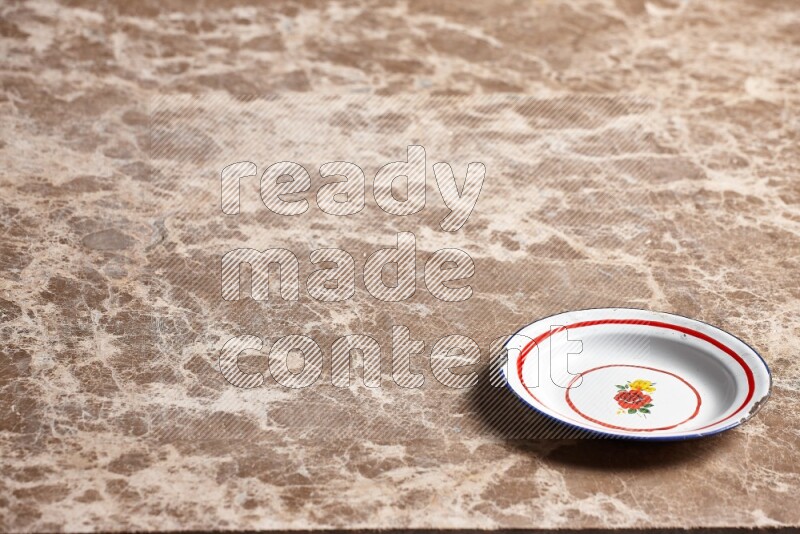 A vintage metal plate on beige marble background