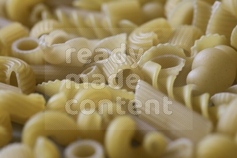Different pasta types on light blue background