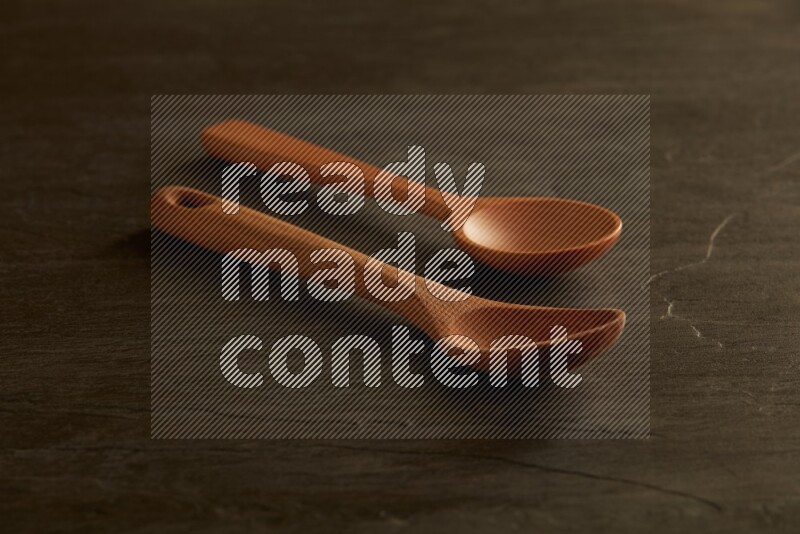 wooden spoon on black slate background