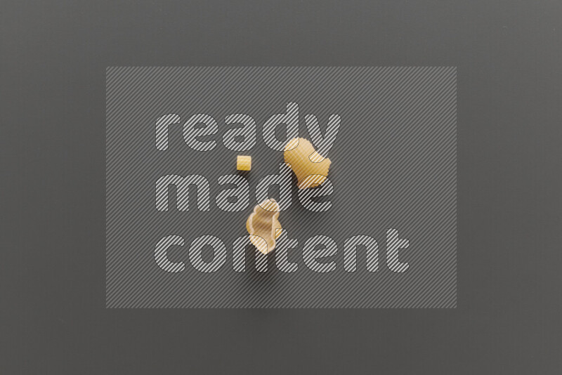 Different pasta types on grey background