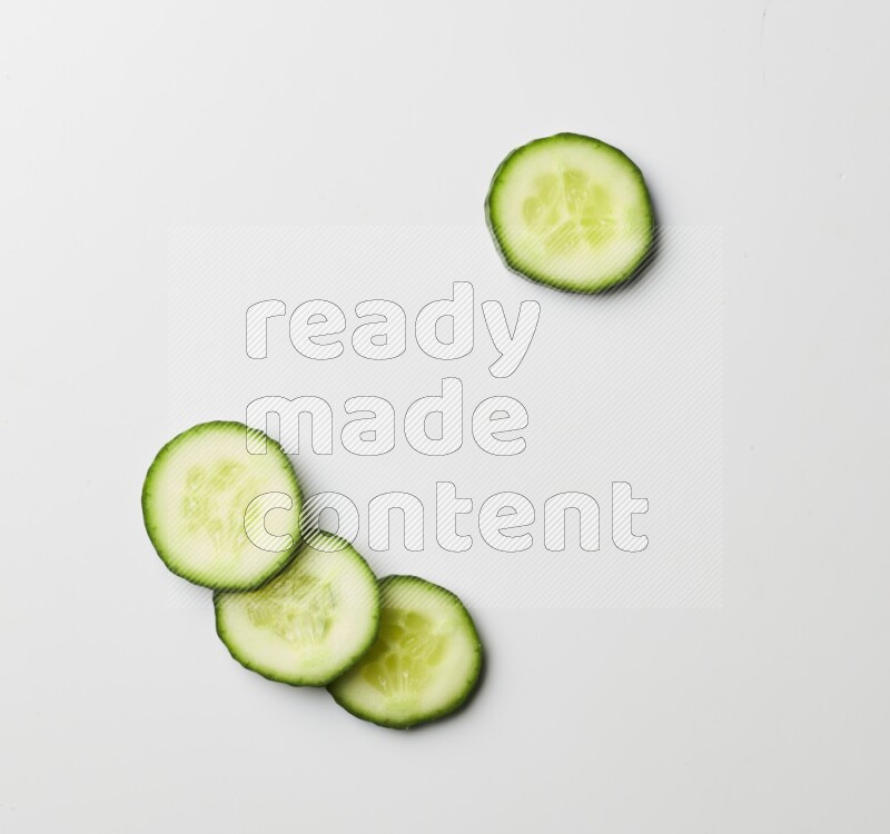 Multiple cucumber slices on white background