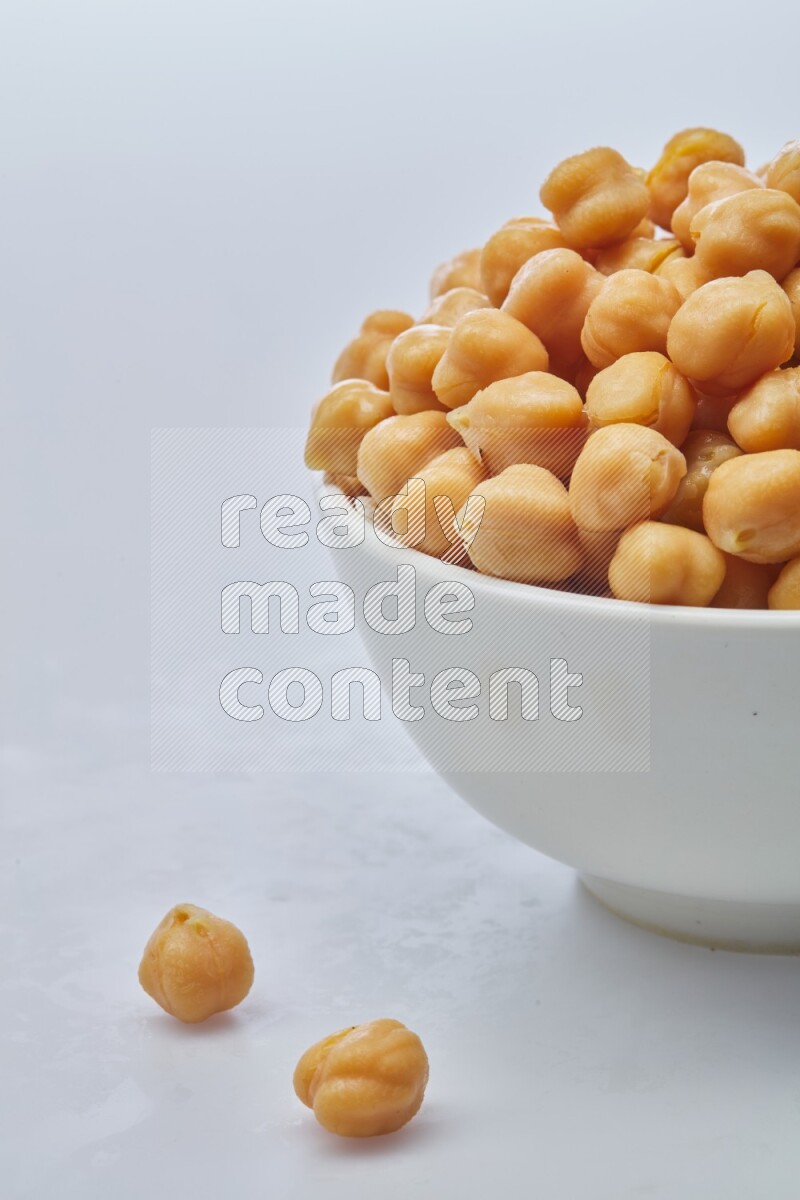 Close up of a boiled chickpeas in a container on white background