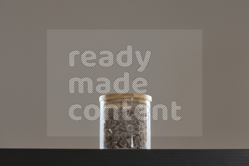 Buttons in a glass jar on black background