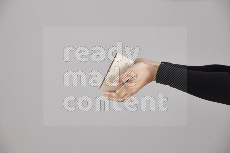 A woman in black abaya holding different pottery essentials in different positions