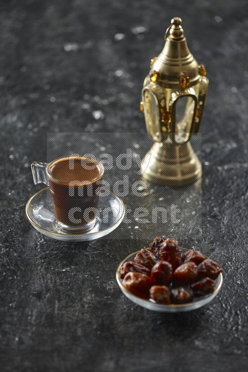 A golden lantern with different drinks, dates, nuts, prayer beads and quran on textured black background