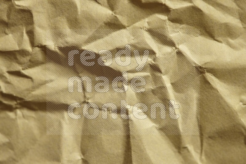 Crumpled craft paper on black background