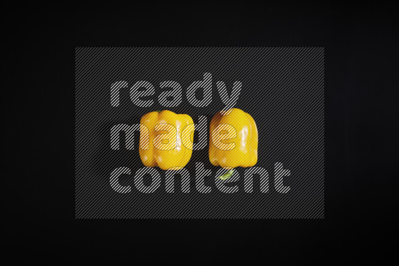 Yellow bell pepper on black background