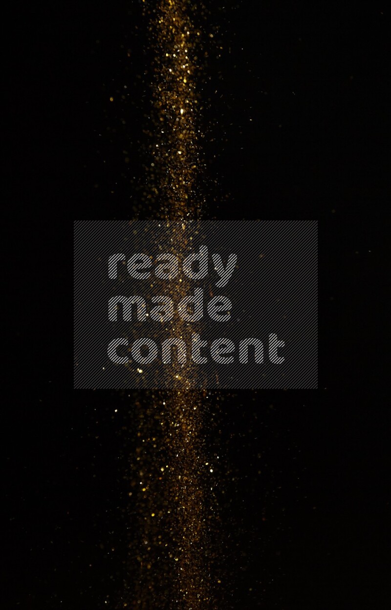 Gold glitter powder isolated on black background