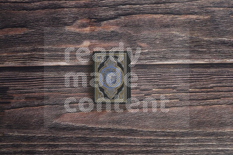 Quran with a prayer beads on wooden background