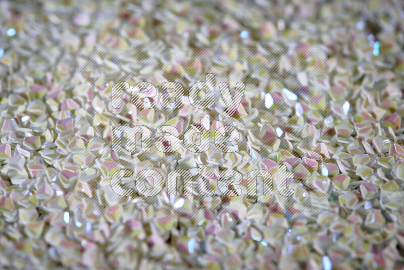 Colorful plastic shards for decoration scattered on a black background