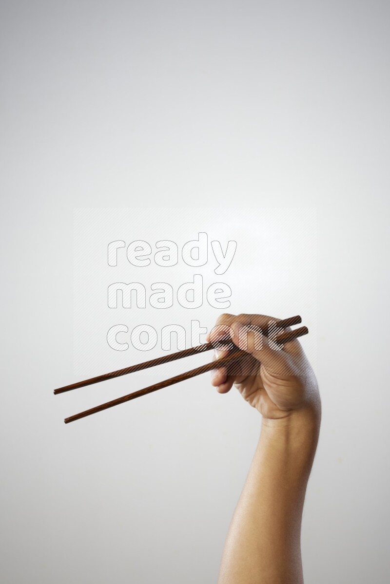 Male Hand Holding Chop Stick on white background