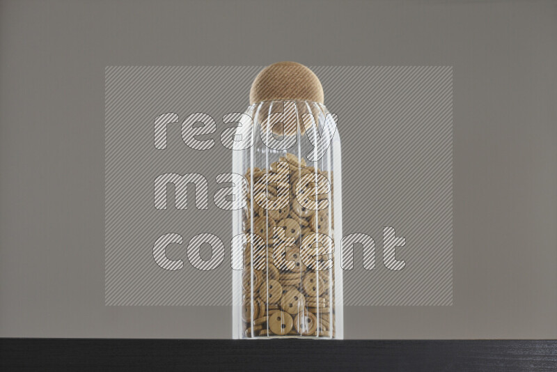 Buttons in a glass jar on black background