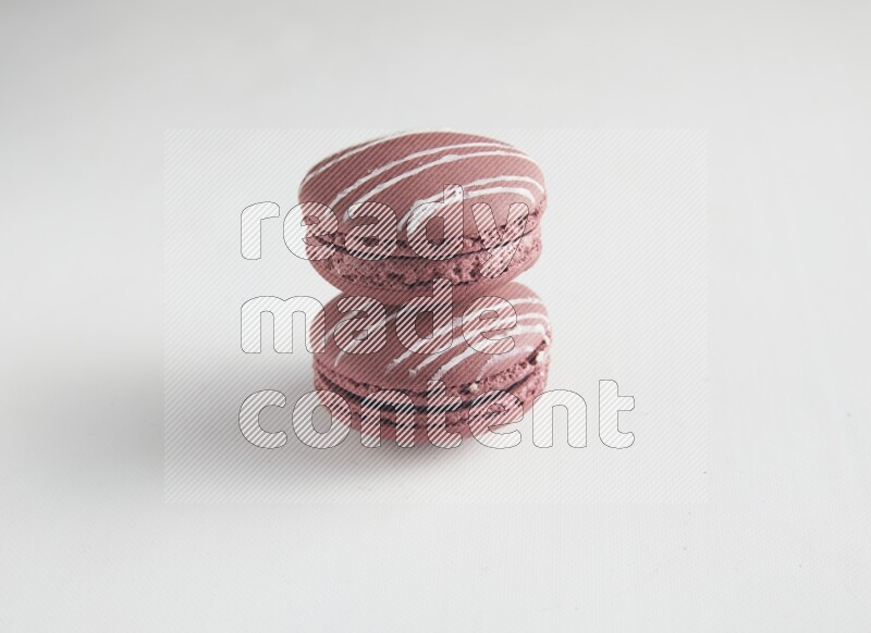 45º Shot of two Red Poppy Flower macarons on white background