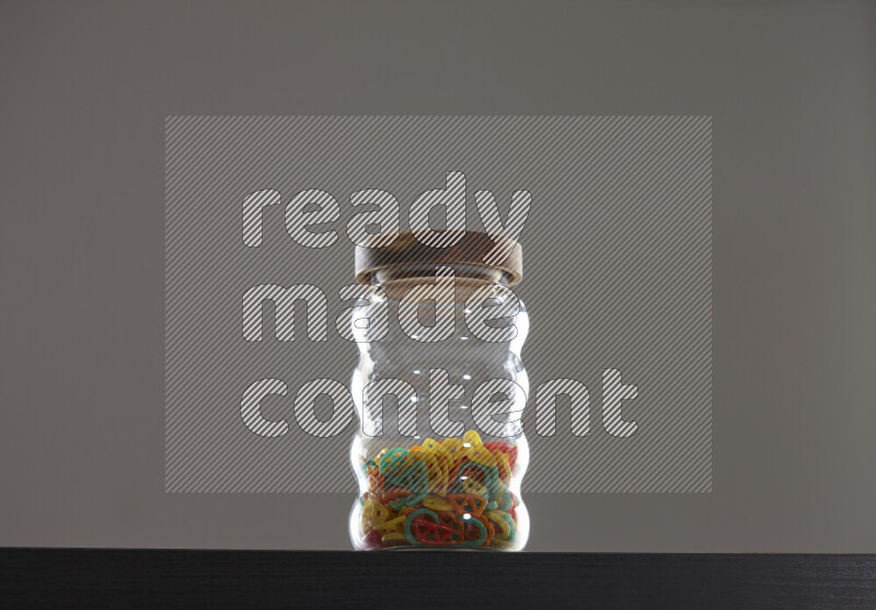 Snacks in a glass jar on black background