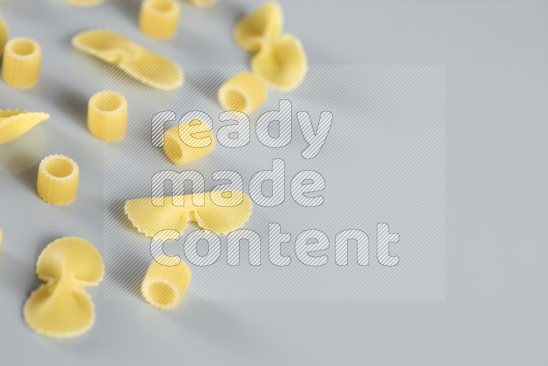 Different pasta types on light blue background