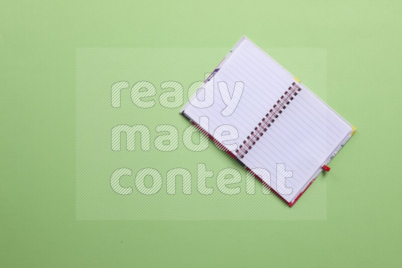 A blank open notebook on green background