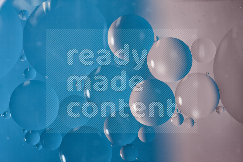 Close-ups of abstract oil bubbles on water surface in shades of white and blue