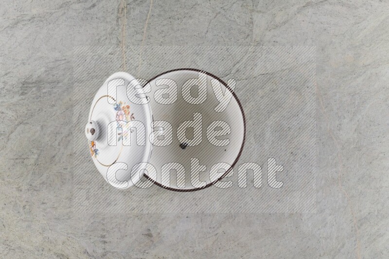 A vintage metal pot on grey marble background