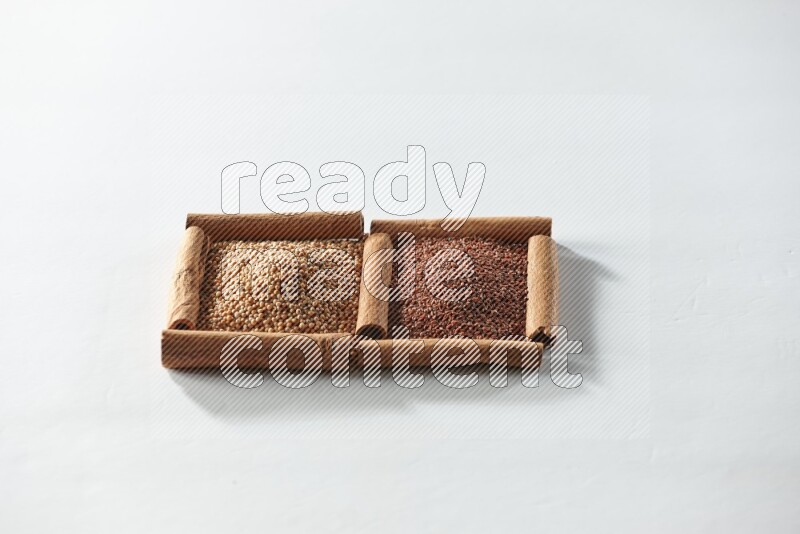 2 squares of cinnamon sticks full of mustard seeds and garden cress on white flooring
