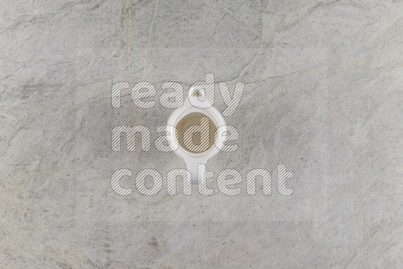 A ceramic milk jug on grey marble background