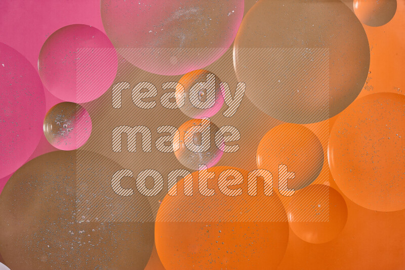 Close-ups of abstract oil bubbles on water surface in shades of brown, orange and pink
