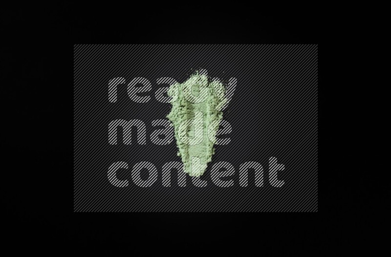Green powder smears on black background