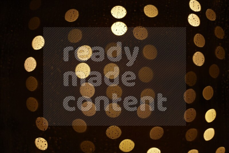 Bokeh light in yellow with water drops