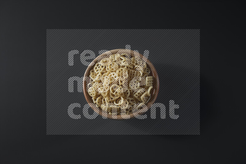 Snacks in a wooden bowl on grey background