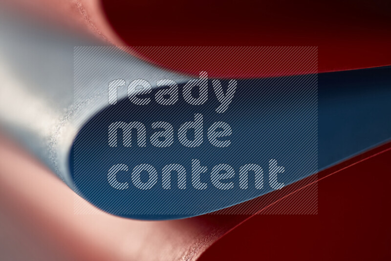 An abstract art showing red and blue paper sheets arranged in an overlapping curves