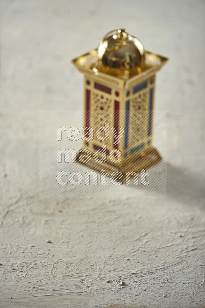 A lantern placed on a textured white background