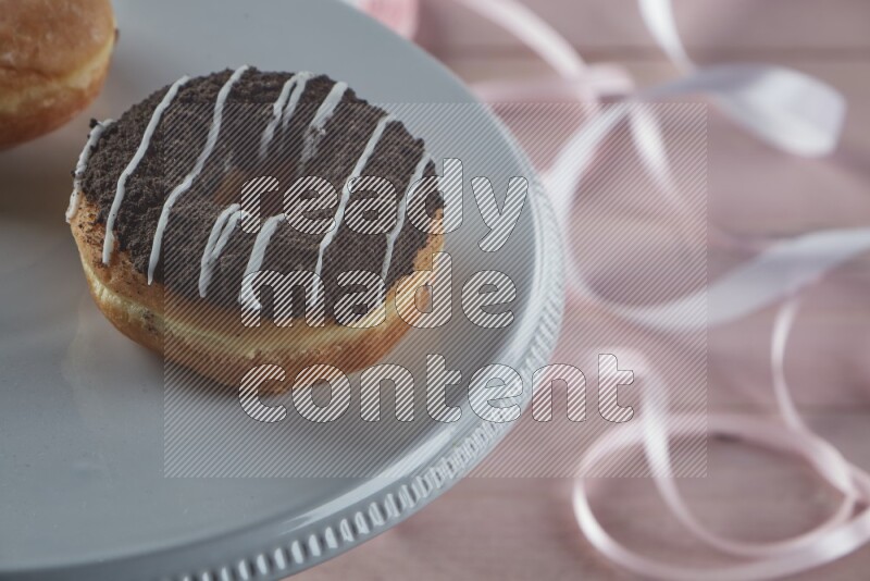 Chocolate crumbs doughnut on pink wooden background