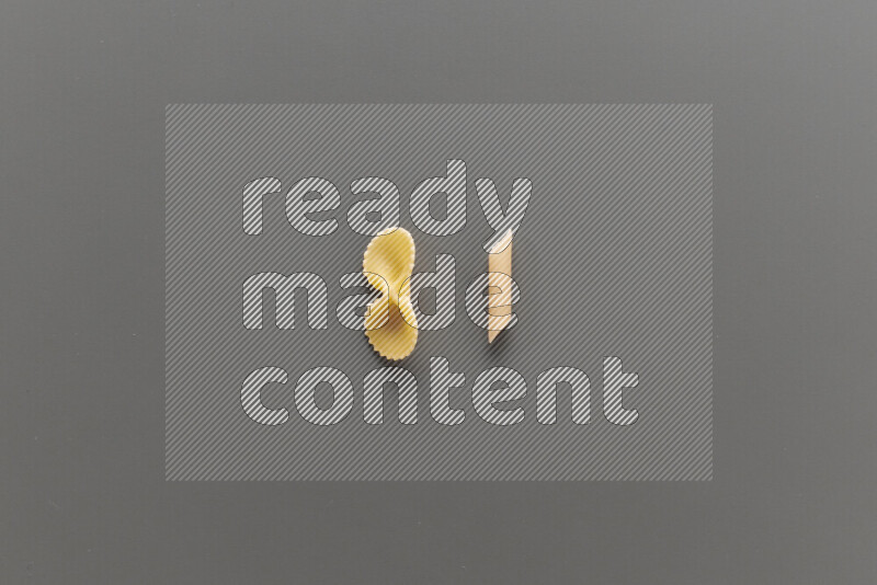 Fiocchi pasta with other types of pasta on grey background