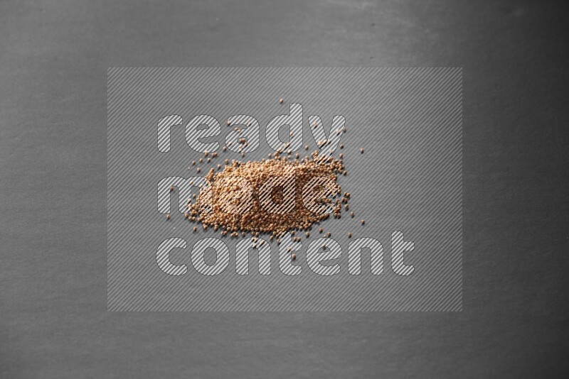 Mustard seeds on a black flooring