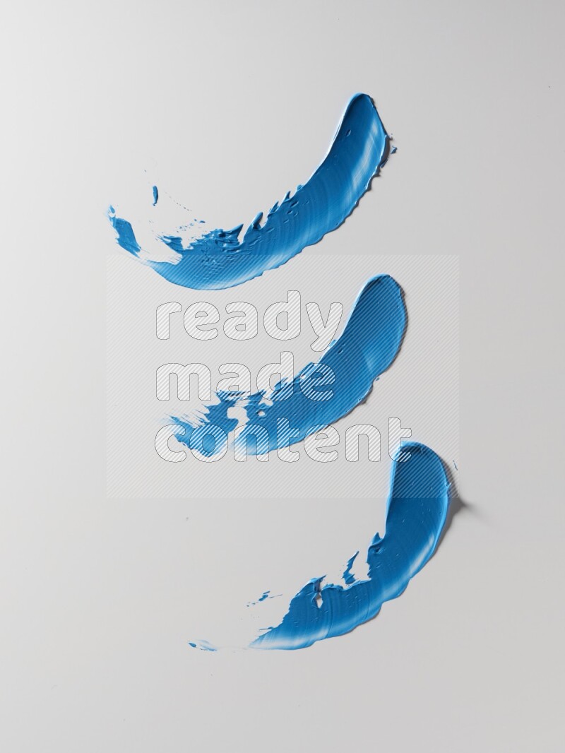 Blue painting knife strokes on white background