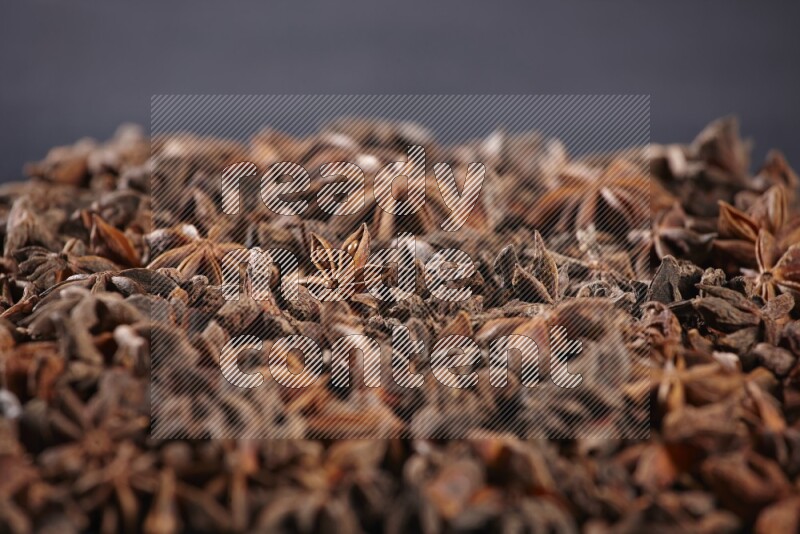 Star Anise herbs fill the frame on black flooring